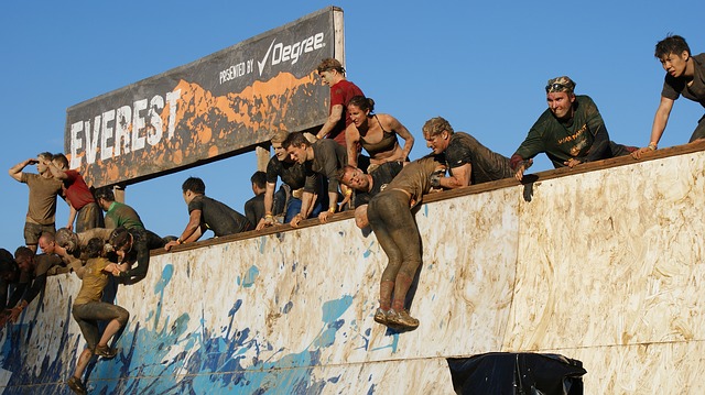 Climbing a wall on the Tough Mudder obstacle course race