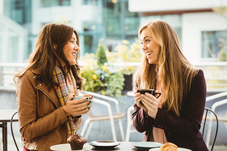 Two woman enjoying each others company over coffee