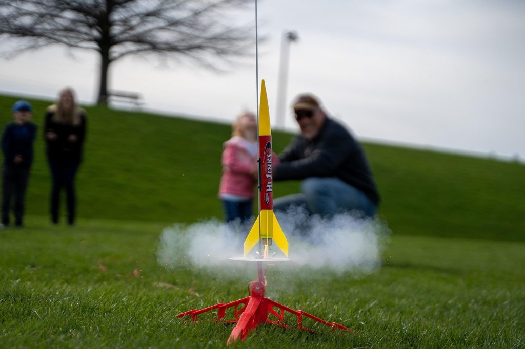 Father and daughter launching a model rocket
