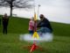 Father and daughter launching a model rocket