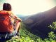 Solo Woman Sitting Looking at a view in the Mountains