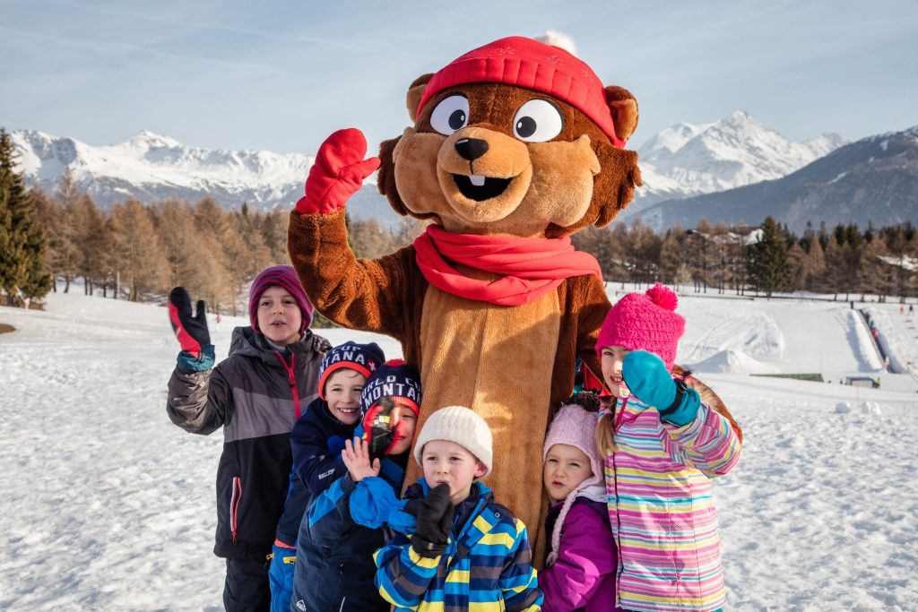 Mascot Bibi on Snow Island in Crans Montana with kids