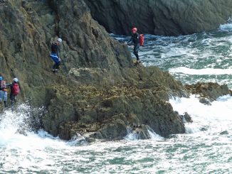 Group coasteering on the cliffs by the sea