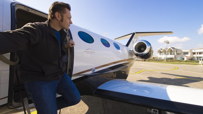 Adventurer steping out of his private jet